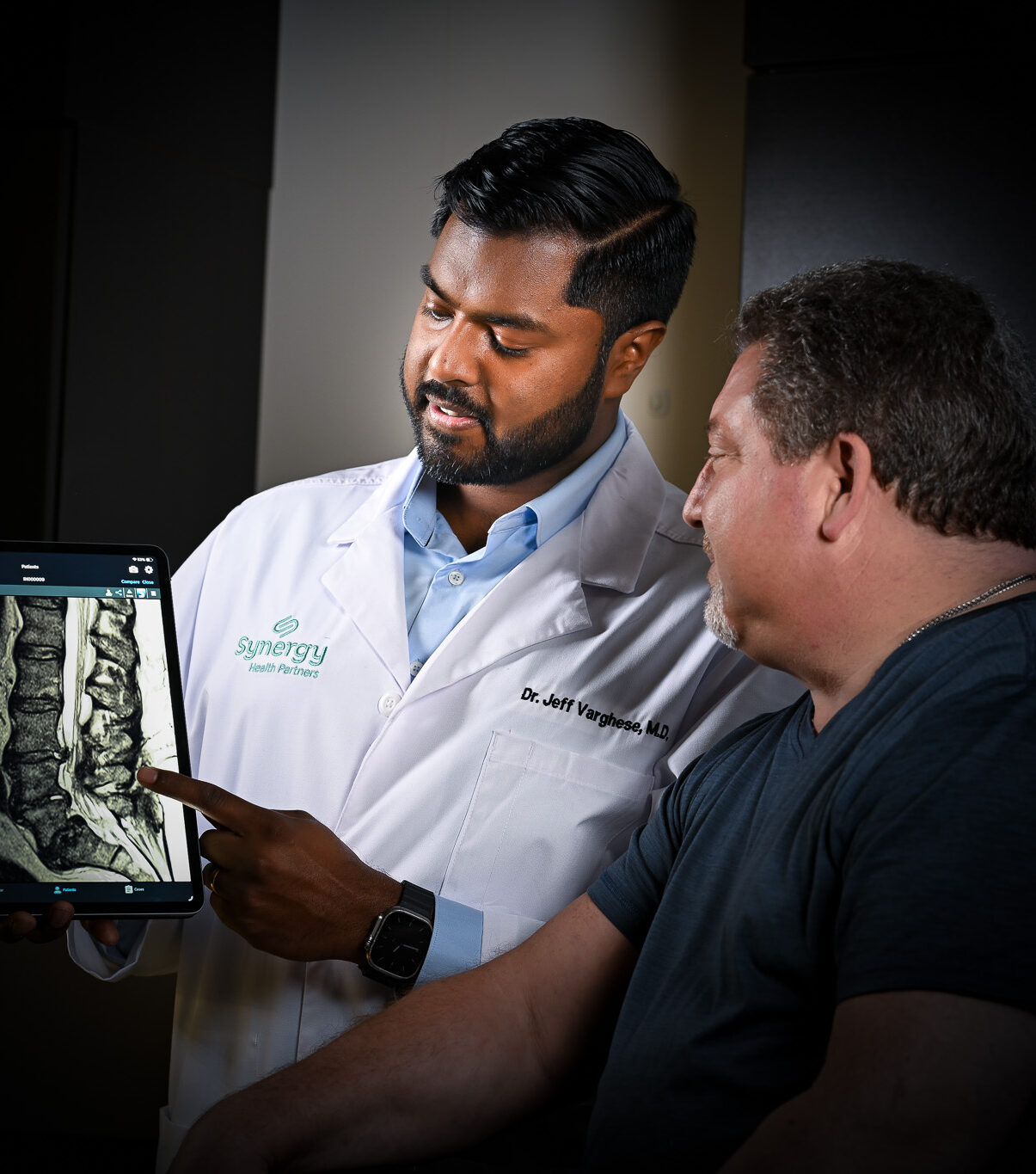 Dr. Varghese reviewing imaging with patient
